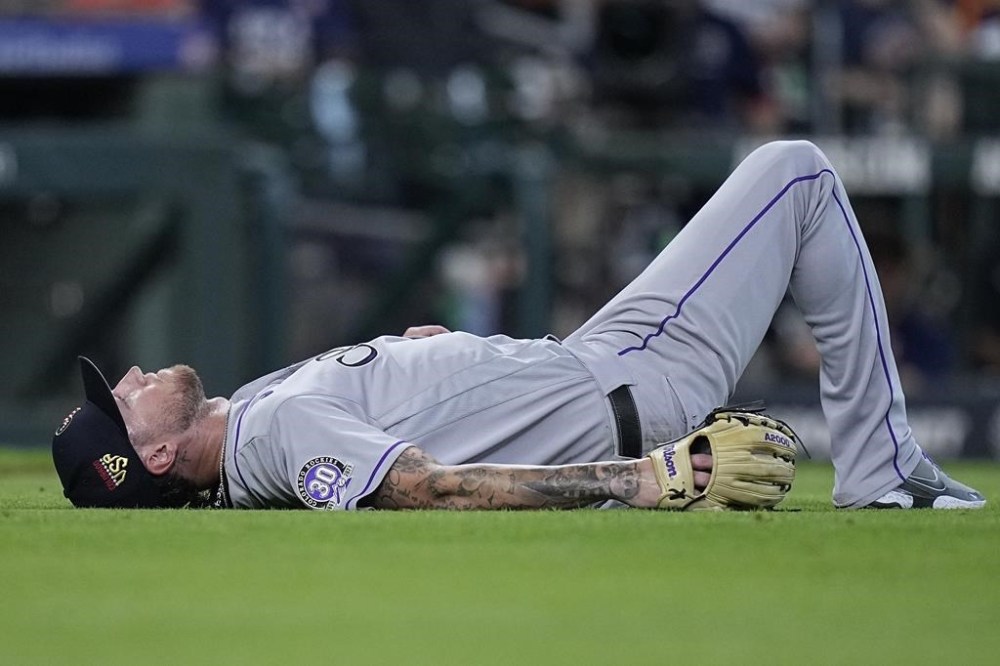 Colorado Rockies starting pitcher Kyle Freeland lays on the ground after an RBI single by Houston Astros designated hitter Corey Julks came up the middle during the fifth inning of a baseball game, Tuesday, July 4, 2023, in Houston. (AP Photo/Kevin M. Cox)