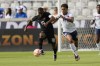 Canada's Junior Hoilett (10) advances the ball as Cuba's Yunior Pérez (15) defends during the first half of a CONCACAF Gold Cup soccer match Tuesday, July 4, 2023, in Houston. (AP Photo/David J. Phillip)