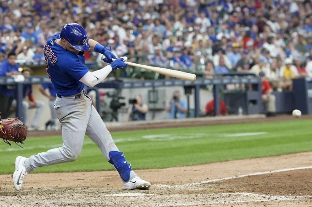 Chicago Cubs' Nico Hoerner hits an RBI single during the 11th inning of a baseball game against the Milwaukee Brewers Tuesday, July 4, 2023, in Milwaukee. (AP Photo/Morry Gash)