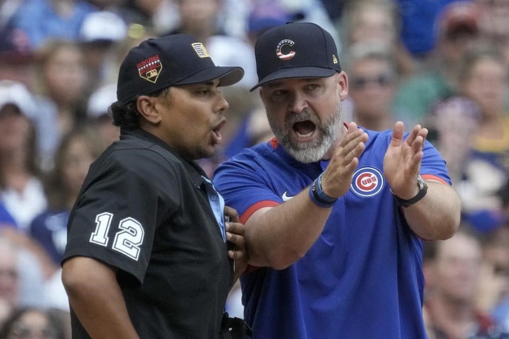 Chicago Cubs manager David Ross aregues with home plate umpire Gerry Davis during the sixth inning of a baseball game against the Milwaukee Brewers Tuesday, July 4, 2023, in Milwaukee. (AP Photo/Morry Gash)