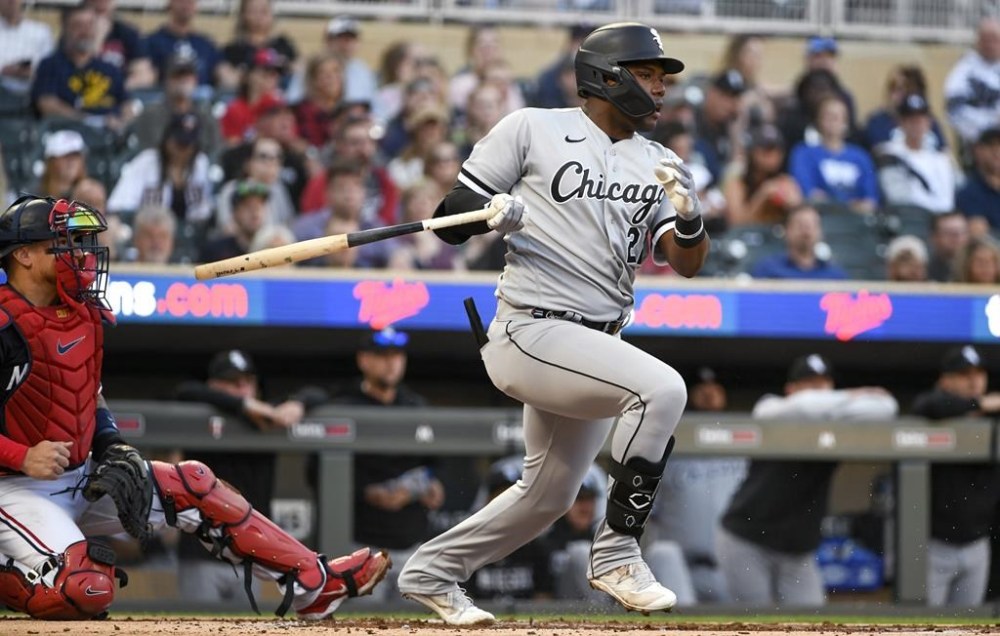 FILE - Chicago White Sox' Oscar Colas follows through after making contact, during the first inning of the team's baseball game against the Minnesota Twins on April 11, 2023, in Minneapolis. The White Sox recalled Colás from Triple-A Charlotte on Tuesday, July 4, confident the Cuban outfielder will perform better than he did at the start of the season. (AP Photo/Craig Lassig, File)