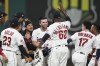 Cleveland Guardians' David Fry, center, is mobbed by teammates after hitting a game-winning single in the tenth inning of a baseball game against the Atlanta Braves, Tuesday, July 4, 2023, in Cleveland. (AP Photo/Sue Ogrocki)
