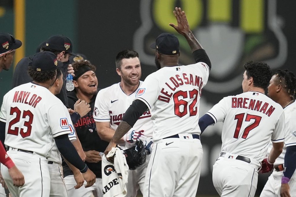 Cleveland Guardians' David Fry, center, is mobbed by teammates after hitting a game-winning single in the tenth inning of a baseball game against the Atlanta Braves, Tuesday, July 4, 2023, in Cleveland. (AP Photo/Sue Ogrocki)