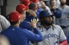 Toronto Blue Jays' Vladimir Guerrero Jr., right, celebrates in the dugout after he scored against the Chicago White Sox during the fourth inning of a baseball game Tuesday, July 4, 2023, in Chicago. (AP Photo/Matt Marton)