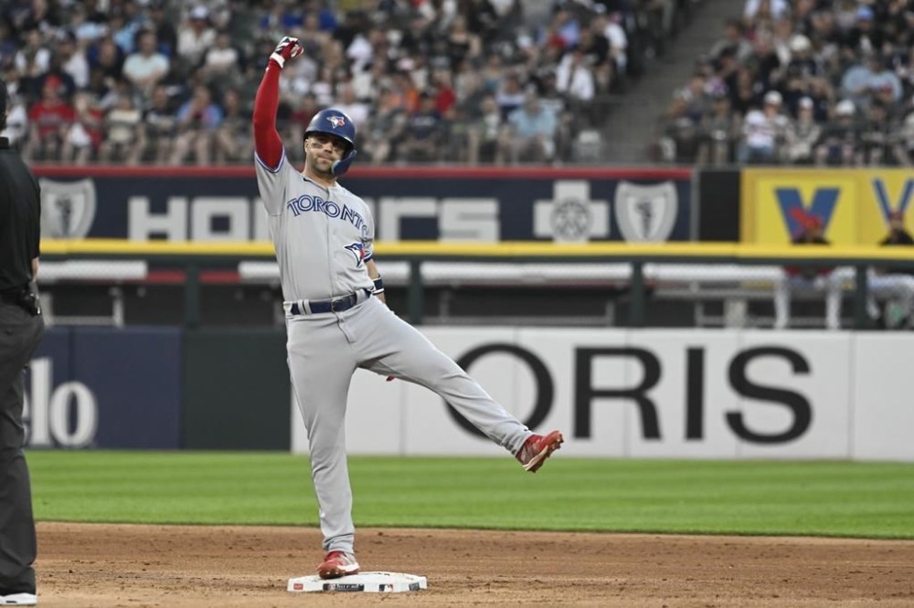 Toronto Blue Jays' Whit Merrifield pumps his arm after he hit a two-run double against the Chicago White Sox during the fourth inning of a baseball game, Tuesday, July 4, 2023, in Chicago. (AP Photo/Matt Marton)