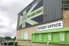 FILE - Signage hangs above the ticket office at the New Lawn, Forest Green Rovers' football ground, in Nailsworth, England. While women’s soccer is growing in popularity in the U.K. - opportunities for women in men’s game remain few and far between. That changed this week when Forest Green Rovers became the first professional soccer team in England to appoint a female head coach. (AP Photo/James Brook, File)