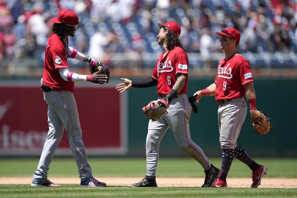 Cincinnati Reds' Elly De La Cruz, from left, Jonathan India and Matt McLain celebrate after a baseball game against the Washington Nationals, Tuesday, July 4, 2023, in Washington. Cincinnati won 8-4. (AP Photo/Patrick Semansky)