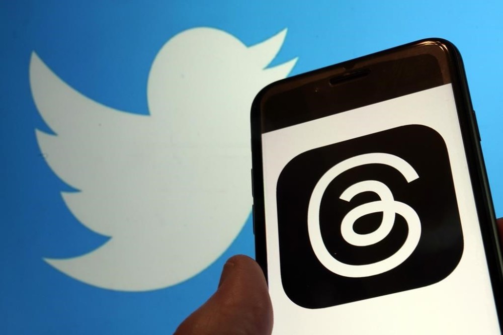 This photo, taken in New York on Wednesday, July 5, 2023, show the logo for Meta's new app Threads, right, and that of Twitter. Meta is poised to unveil the new app that appears to mimic Twitter — a direct challenge to the social media platform owned by Elon Musk. A listing for the Threads app appeared on Apple's App Store, indicating it would debut as early as Thursday. (AP Photo/Richard Drew)
