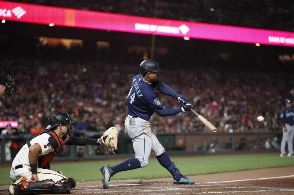Seattle Mariners' Julio Rodriguez hits a double RBI against San Francisco Giants catcher Blake Sabol (2) in the ninth inning of a baseball game in San Francisco, Monday, July 3, 2023. (AP Photo/Josie Lepe)