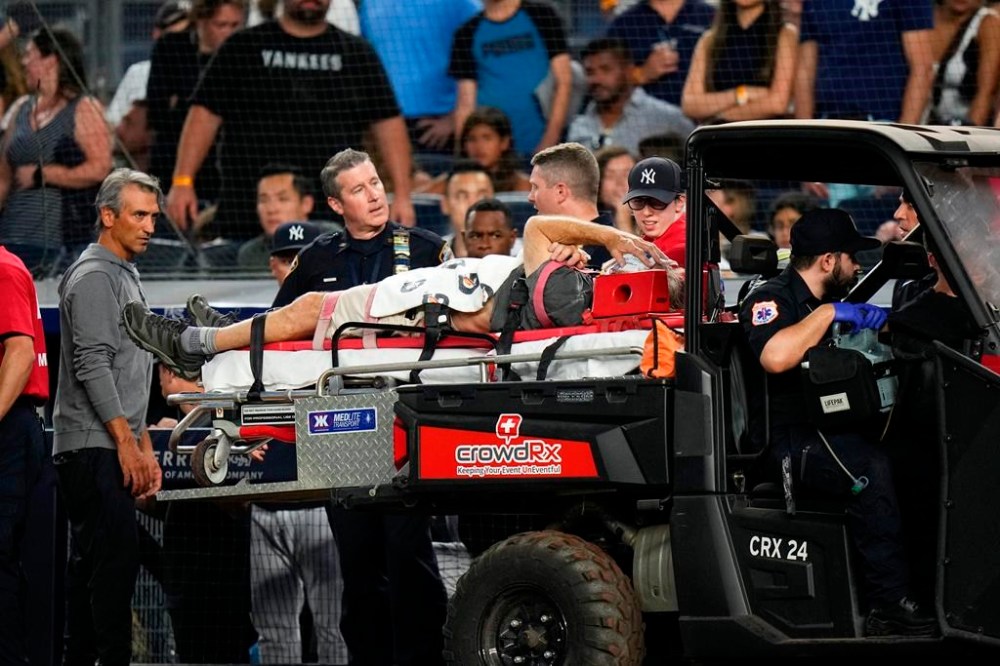 A camera operator who was injured on a throwing error by Baltimore Orioles' Gunnar Henderson has ben placed on a cart during the fifth inning of the Orioles' baseball game against the New York Yankees on Wednesday, July 5, 2023, in New York. (AP Photo/Frank Franklin II)