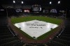 A tarp covers the infield during a rain delay before a baseball game between the Toronto Blue Jays and the Chicago White Sox in Chicago, Wednesday, July 5, 2023. A flash flood watch has been issued for Chicago-area counties ahead of heavy rain and a severe storm threat. (AP Photo/Nam Y. Huh)