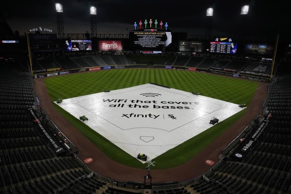 A tarp covers the infield during a rain delay before a baseball game between the Toronto Blue Jays and the Chicago White Sox in Chicago, Wednesday, July 5, 2023. A flash flood watch has been issued for Chicago-area counties ahead of heavy rain and a severe storm threat. (AP Photo/Nam Y. Huh)