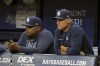 Tampa Bay Rays bench coach Rodney Linares, left, and manager Kevin Cash watch from the dugout during the first inning of a baseball game against the Philadelphia Phillies, Wednesday, July 5, 2023, in St. Petersburg, Fla. (AP Photo/Steve Nesius)