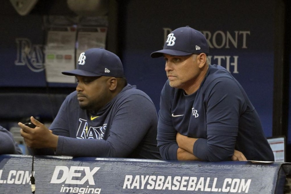 Tampa Bay Rays bench coach Rodney Linares, left, and manager Kevin Cash watch from the dugout during the first inning of a baseball game against the Philadelphia Phillies, Wednesday, July 5, 2023, in St. Petersburg, Fla. (AP Photo/Steve Nesius)