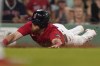 Boston Red Sox's Christian Arroyo slides home to score on a fielding error in the sixth inning of a baseball game against the Texas Rangers, Wednesday, July 5, 2023, in Boston. (AP Photo/Steven Senne)