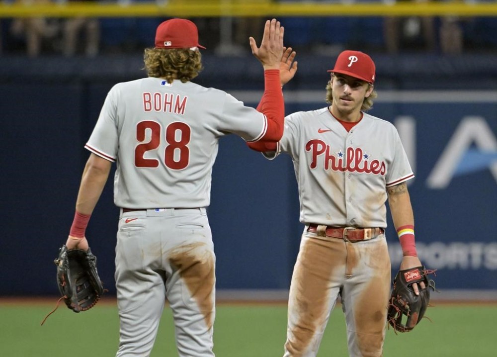 Philadelphia Phillies' Alec Bohm (28) and Bryson Stott celebrate an 8-4 win over the Tampa Bay Rays during a baseball game Wednesday, July 5, 2023, in St. Petersburg, Fla. (AP Photo/Steve Nesius)