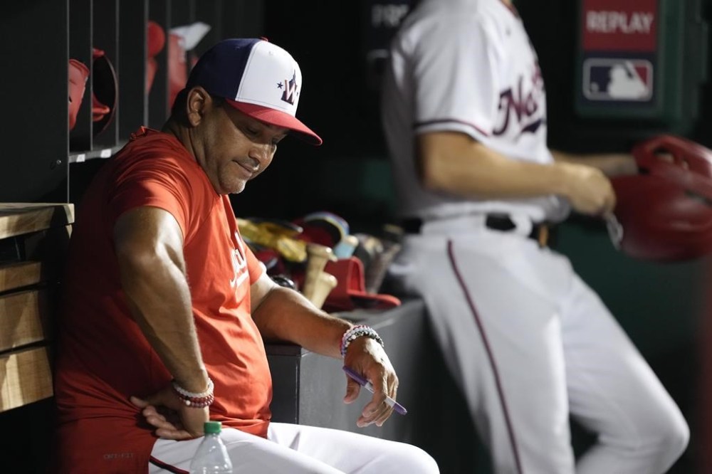 Washington Nationals manager Dave Martinez sits in the dugout in the eighth inning of a baseball game against the Cincinnati Reds, Wednesday, July 5, 2023, in Washington. (AP Photo/Patrick Semansky)