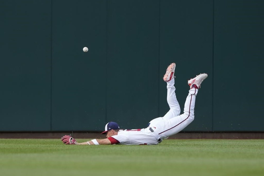 Washington Nationals center fielder Alex Call is unable to make a catch on Cincinnati Reds' Tyler Stephenson's double in the second inning of a baseball game, Wednesday, July 5, 2023, in Washington. Spencer Steer scored on the play. (AP Photo/Patrick Semansky)
