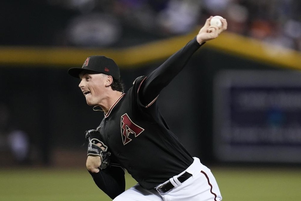 Arizona Diamondbacks starting pitcher Tommy Henry throws against the New York Mets during the first inning of a baseball game Wednesday, July 5, 2023, in Phoenix. (AP Photo/Ross D. Franklin)