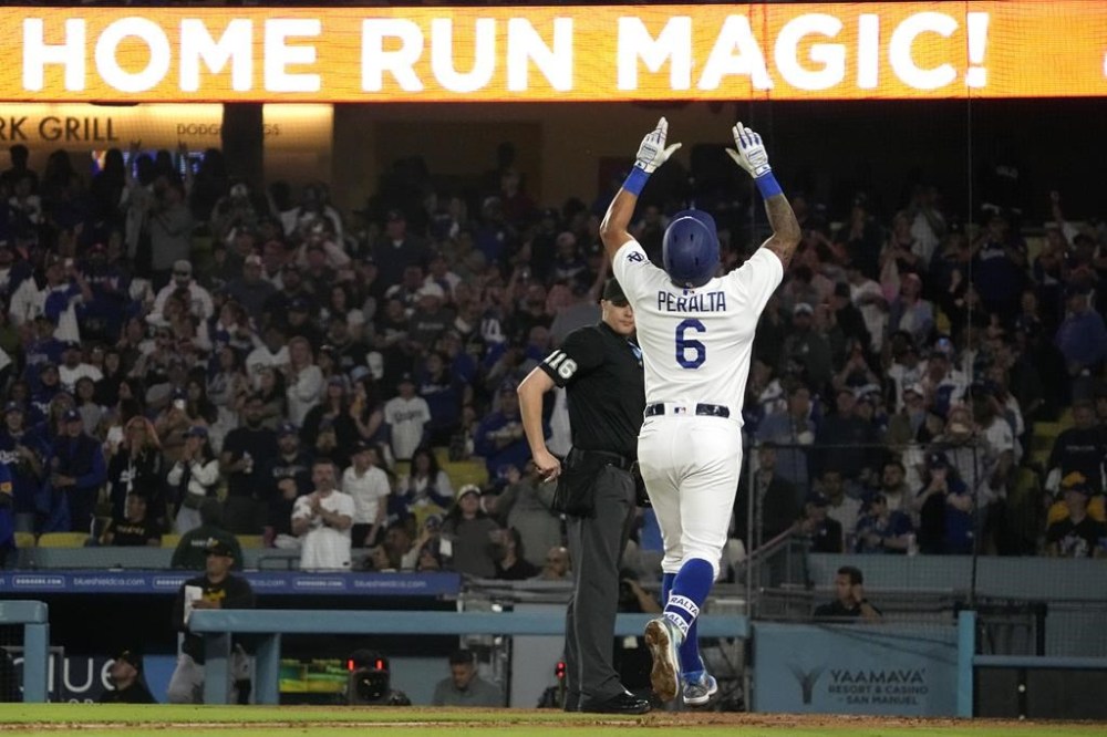 Los Angeles Dodgers' David Peralta gestures as he scores after hitting a solo home run during the fifth inning of a baseball game against the Pittsburgh Pirates Wednesday, July 5, 2023, in Los Angeles. (AP Photo/Mark J. Terrill)