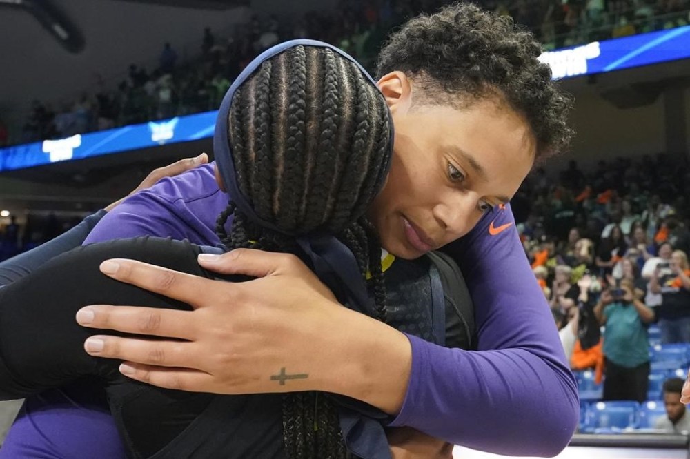 FILE - Phoenix Mercury center Brittney Griner, right, hugs former college teammate Dallas Wings guard Odyssey Sims after a WNBA basketball basketball game in Arlington, Texas, Friday, June 9, 2023. Sims is on her second contract of the season in a return to the Wings, mature enough to call the younger version of herself a bad teammate while knowing she has to be a good one for the current faces of the franchise, Arike Ogunbowale and Satou Sabally. (AP Photo/LM Otero, File)