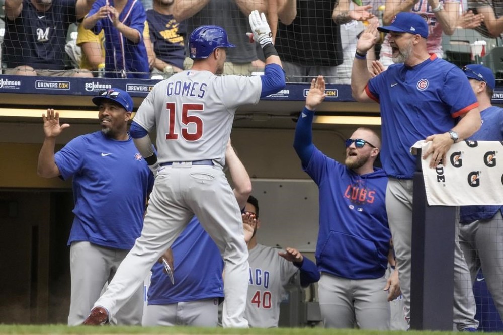 Chicago Cubs' Yan Gomes is congratulated after hitting a two-run home run during the eighth inning of a baseball game against the Milwaukee Brewers Thursday, July 6, 2023, in Milwaukee. (AP Photo/Morry Gash)