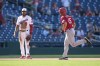 Cincinnati Reds' Nick Senzel, right, rounds the bases past Washington Nationals third baseman Jeimer Candelario after hitting a two-run home run in the 10th inning of a baseball game, Thursday, July 6, 2023, in Washington. Cincinnati won 5-4. (AP Photo/Patrick Semansky)