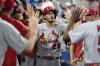 St. Louis Cardinals third baseman Nolan Arenado (28) is congratulated by his teammates after hitting a solo home run in the sixth inning of a baseball game against the Miami Marlins, Thursday, July 6, 2023, in Miami. (AP Photo/Marta Lavandier)