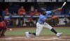 Philadelphia Phillies catcher Garrett Stubbs, left, blocks a pitch in the dirt as Tampa Bay Rays' Randy Arozarena, right, strikes out to end the fourth inning of a baseball game Thursday, July 6, 2023, in St. Petersburg, Fla. (AP Photo/Steve Nesius)