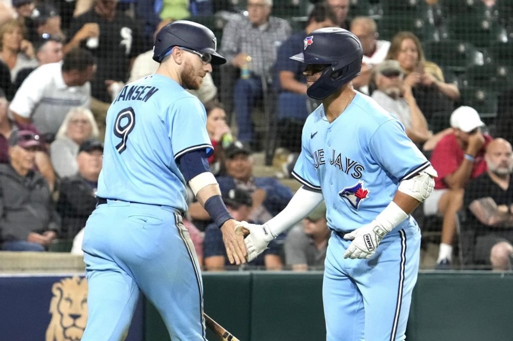 Toronto Blue Jays' Whit Merrifield, right, celebrates with Danny Jansen after hitting a solo home run against the Chicago White Sox during the sixth inning in the second baseball game of a doubleheader Thursday, July 6, 2023, in Chicago. (AP Photo/Nam Y. Huh)