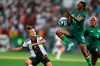 Lina Magullfrom Germany, left, fights for the ball with Agness Musesa from Zambia, center, during the women's international soccer match between Germany and Zambia at Sportpark Ronhof Thomas Sommer in Furth, Germany, Friday July 7, 2023. (Daniel Karmann/dpa via AP)