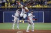 Atlanta Braves' Ronald Acuna Jr., center, celebrates with Ozzie Albies, left, and Orlando Arcia after the team's 2-1 win over the Tampa Bay Rays in a baseball game Friday, July 7, 2023, in St. Petersburg, Fla. (AP Photo/Mike Carlson)