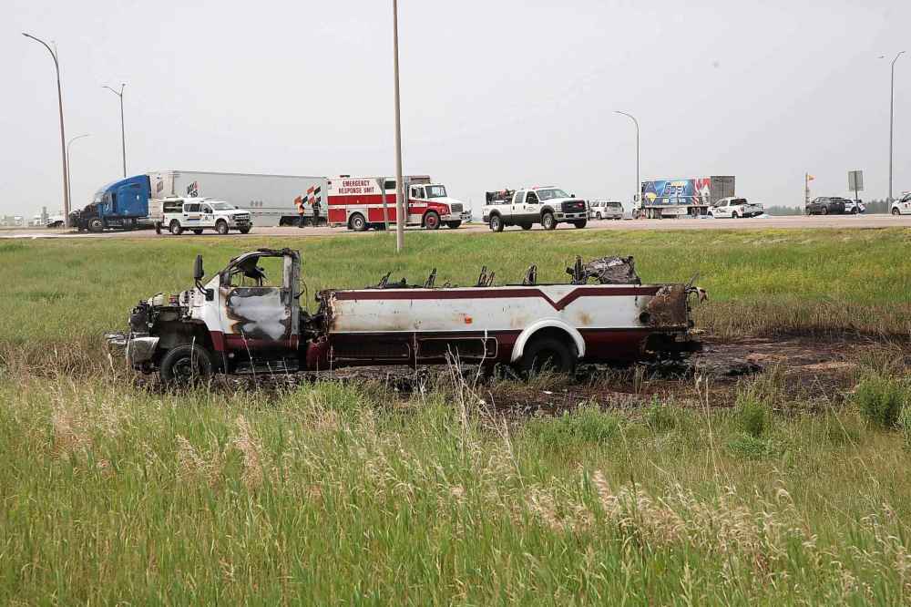 A small burned out transport bus lies in the ditch on the south side of the Trans-Canada Highway. (Matt Goerzen / The Brandon Sun)