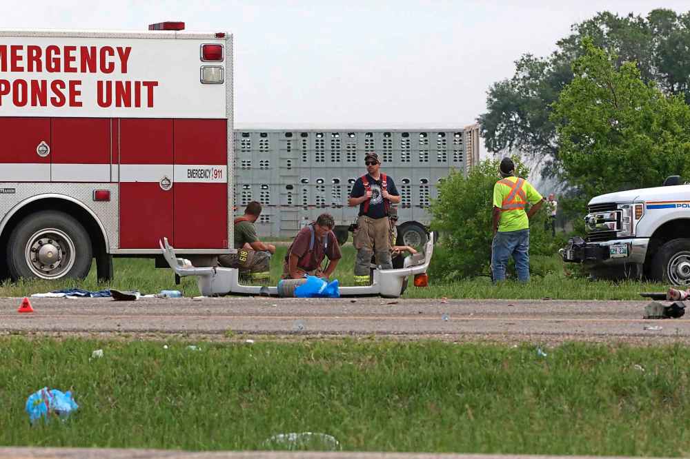 Exhausted emergency workers take a break at the scene of a collision between a small busy and a semi truck at the intersection of the Trans-Canada Highway and Highway 5 near Carberry on Thursday afternoon. (Matt Goerzen / The Brandon Sun)