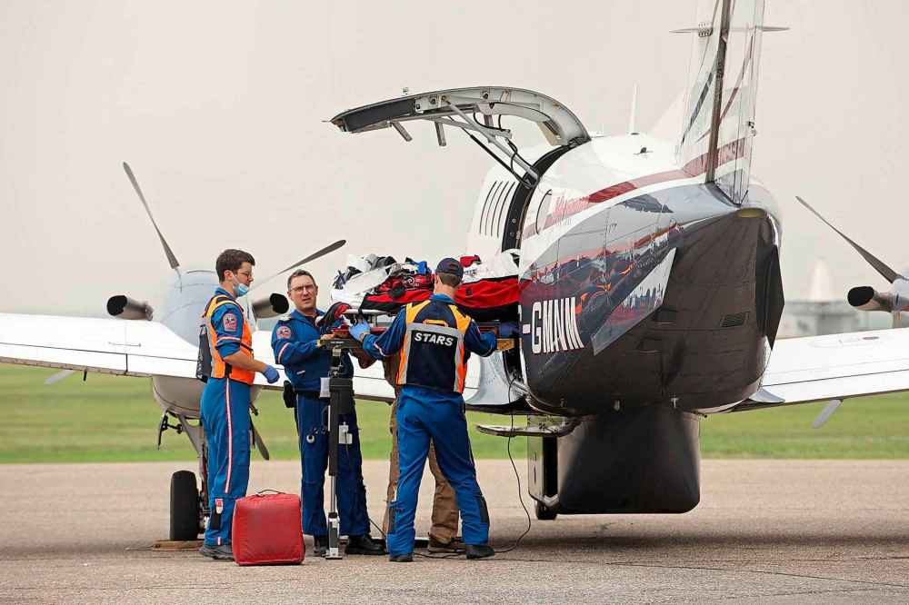 A critical care team loads a victim of the Trans-Canada Highway mass casualty collisio for transport to the Health Sciences Centre in Winnipeg at the Brandon Municipal Airport. (Tim Smith / The Brandon Sun)