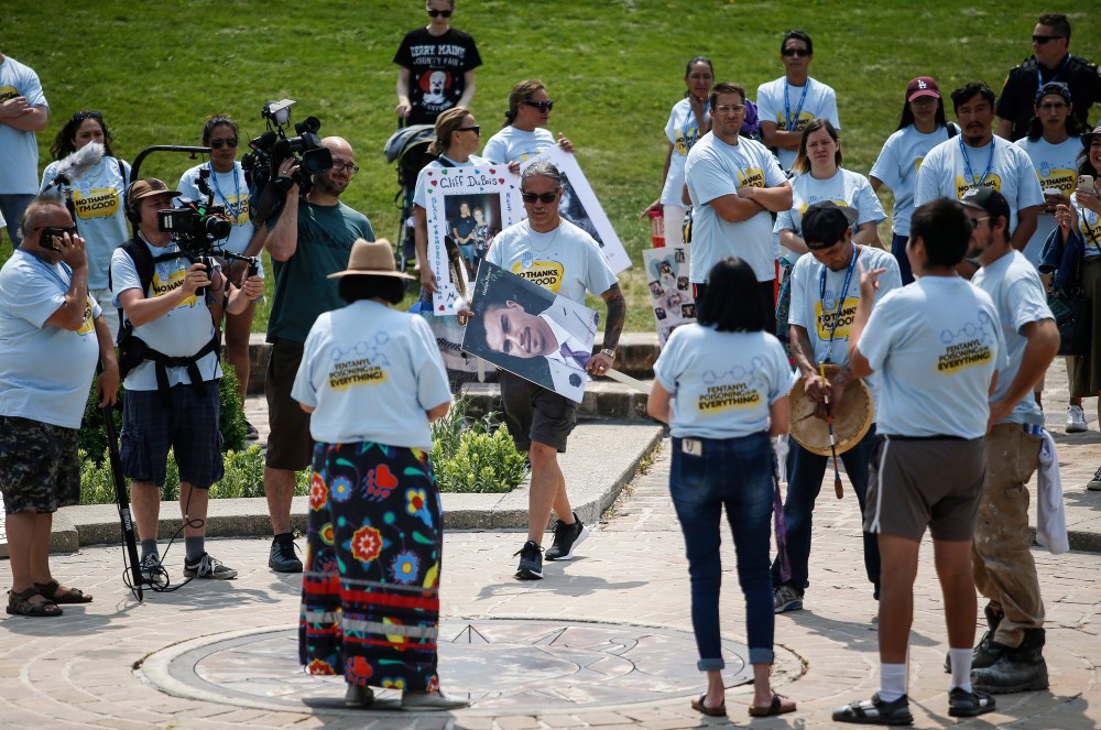JOHN WOODS / WINNIPEG FREE PRESS
Joseph Fourre, centre, carries a large image of his son, Harlan, during the walk. “My son wasn’t an addict. He didn’t have addiction issues. He went out and made a bad choice one night, and it cost him his life,” Fourre said.