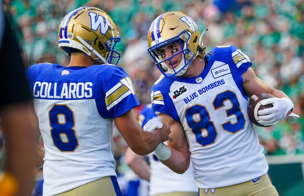 Winnipeg Blue Bombers wide receiver Dalton Schoen (83) celebrates with quarterback Zach Collaros (8) after scoring a touchdown against the Saskatchewan Roughriders during the first half. (Heywood Yu / The Canadian Press)