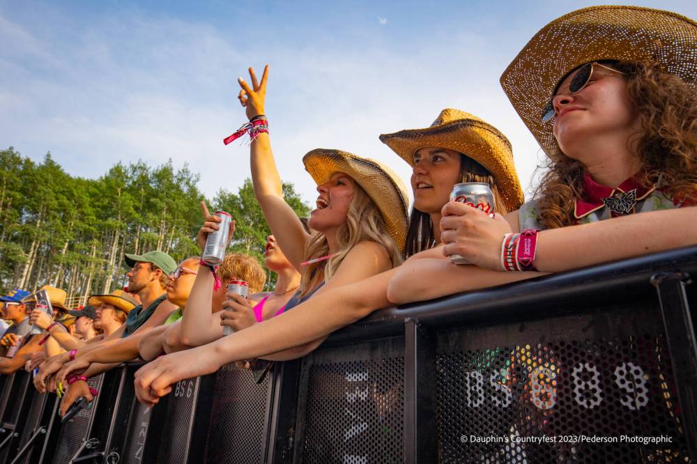 <p>DAUPHIN’S COUNTRYFEST</p>
                                <p>Despite sweltering temperatures, fans crowded together to get close to the action onstage.</p>