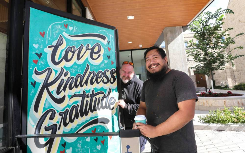 RUTH BONNEVILLE / WINNIPEG FREE PRESS FILES
Last year, when a trash can was thrown through the door of Harrisons Coffee Co., owner Al Dawson (right) had an artist, Joseph Pilapil, decorate it and he auctioned it off as an art piece.