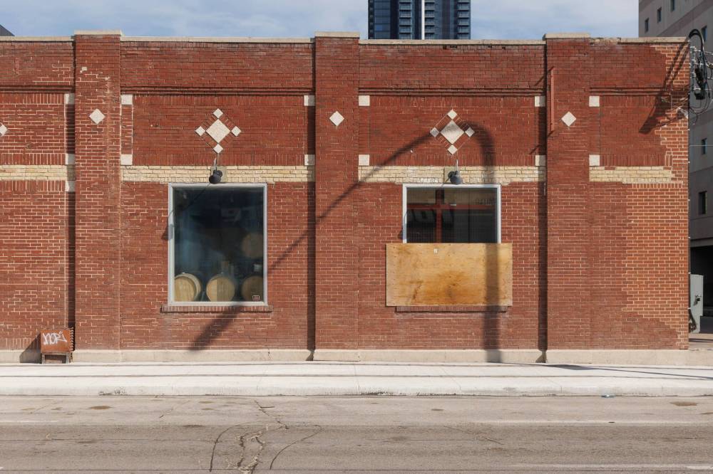 MIKE DEAL / WINNIPEG FREE PRESS
A window is boarded up after it was vandalized at Devil May Care Brewing Company in downtown.
