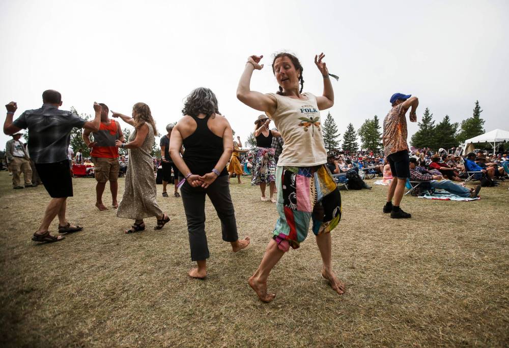 JOHN WOODS / WINNIPEG FREE PRESS
Kat Rother dances as Finjan performs on the Big Bluestem stage at the Winnipeg Folk Festival in Birds Hill Park Sunday.