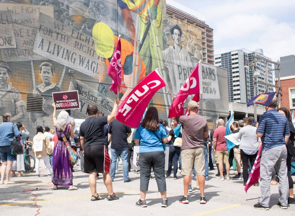 A large crowd of people joined the Save Public Health Care Rally, which went from the corner of Broadway and Main to the Union Centre — across the street from the Fort Garry Hotel, July 11, 2023. (Mike Thiessen / Winnipeg Free Press)