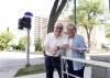 RUTH BONNEVILLE / WINNIPEG FREE PRESS
                                Rev. Sam Argenziano and parishioner Maria Doerr, who chose the wording when applying for the honorary naming, stand next to the street sign at River Avenue and Nassau Street North that honours the well-known Winnipeg Catholic priest.