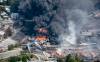 Paul Chiasson / The Canadian Press files
                                Smoke rises from railway cars that were carrying crude oil after derailing in downtown Lac-Megantic, Que., Saturday, July 6, 2013.