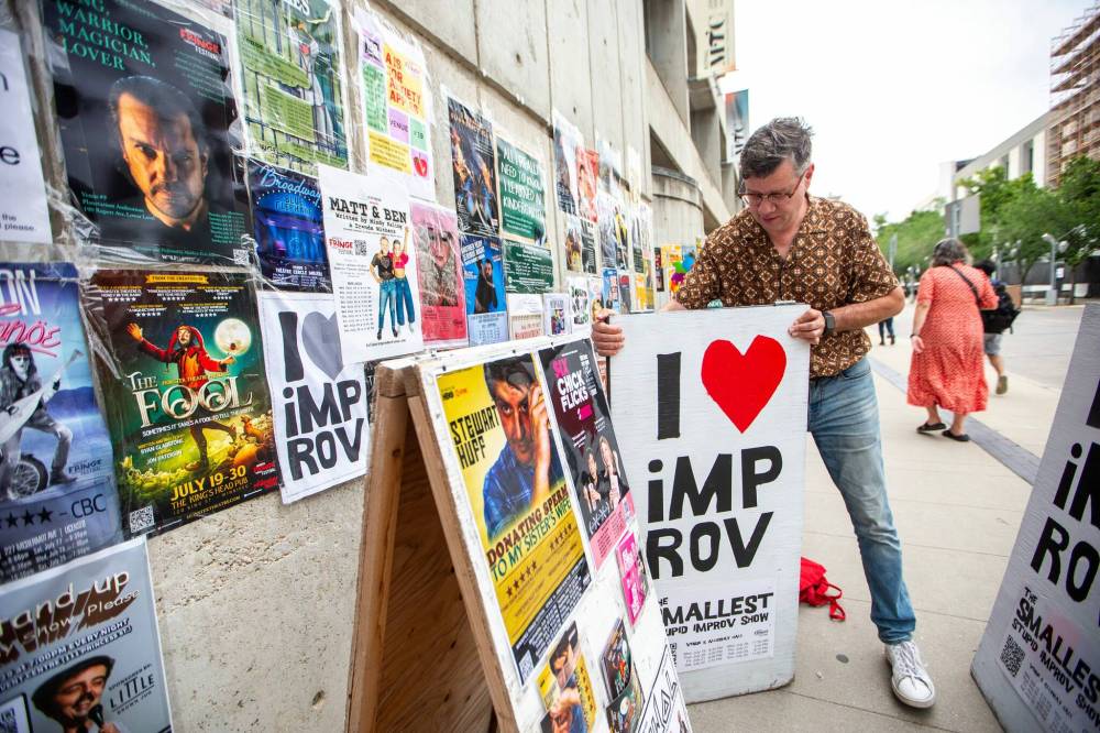 MIKAELA MACKENZIE PHOTOS / WINNIPEG FREE PRESS
Stephen Sim puts out a new sandwich board at the Royal Manitoba Theatre Company.