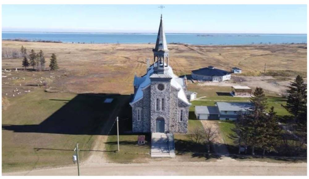 Community members from Minegoziibe Anishinabe, also known as Pine Creek First Nation, are planning to excavate the basement of a Catholic church in an attempt to recover remains from potential unmarked graves believed to be buried there. (Justin Richard photo)