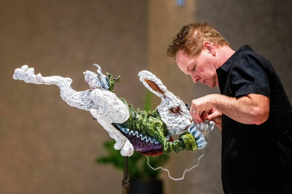 MIKAELA MACKENZIE / WINNIPEG FREE PRESS
Charlie Johnston adjusts his sculpture, inspired by Alice’s Adventures in Wonderland.