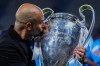 Manchester City's head coach Pep Guardiola kisses the trophy after winning the Champions League final soccer match between Manchester City and Inter Milan at the Ataturk Olympic Stadium in Istanbul, Turkey, Sunday, June 11, 2023. Manchester City won 1-0. (AP Photo/Manu Fernandez)