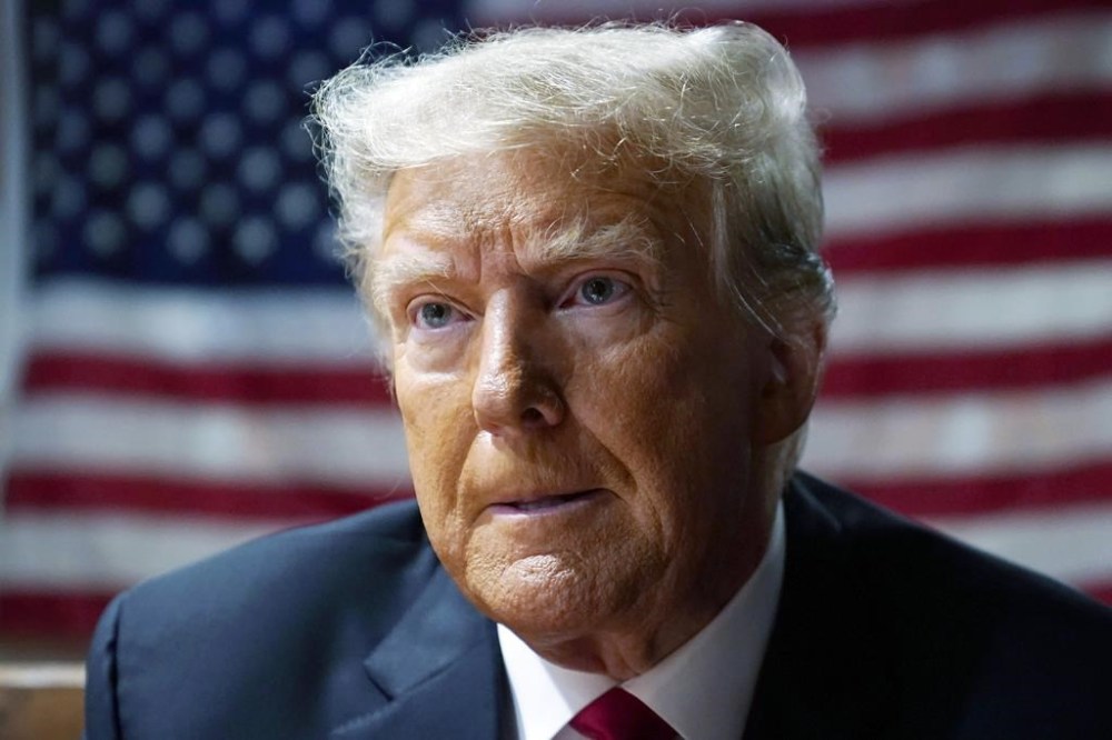 FILE - Former President Donald Trump speaks with supporters at the Westside Conservative Breakfast, June 1, 2023, in Des Moines, Iowa. Trump’s claims that absolute presidential immunity and free speech rights shield him from the defamation claims of E. Jean Carroll, a New York columnist, were rejected Thursday, June 29, by a federal judge. (AP Photo/Charlie Neibergall, File)