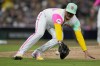 San Diego Padres relief pitcher Adrian Morejon fields a ground ball before throwing to first for the out on New York Mets' Luis Guillorme during the sixth inning of a baseball game Friday, July 7, 2023, in San Diego. (AP Photo/Gregory Bull)